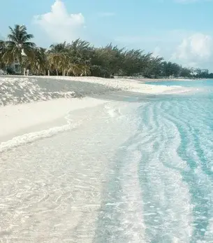 Seven Mile Beach skyline and landmark attractions seen on descent during a private jet charter approach