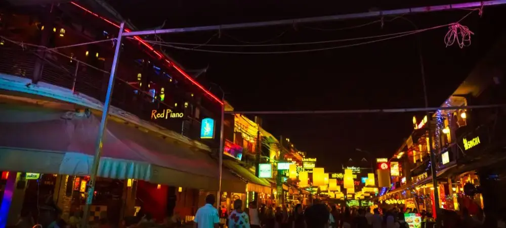 Vibrant nightlife scene on Pub Street in Siem Reap with colorful neon signs and bustling crowds