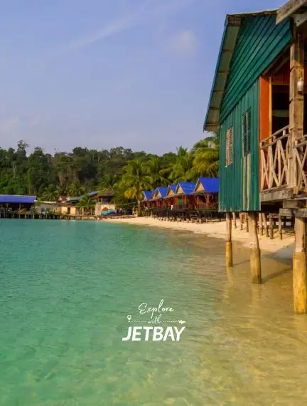 Colorful overwater bungalows on stilts above turquoise waters in tropical Sihanoukville, Cambodia