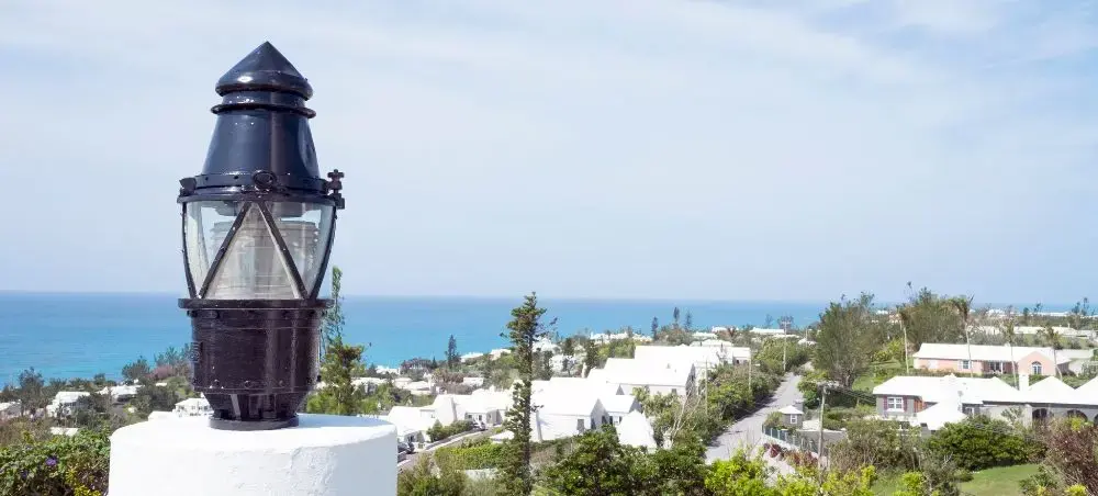 Historic lighthouse overlooking Southampton's turquoise coastline and white-roofed homes in Bermuda
