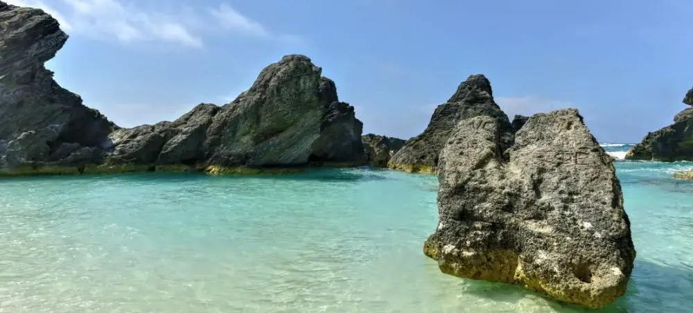 Crystal clear turquoise waters and dramatic limestone rock formations at Southampton's pristine beaches in Bermuda