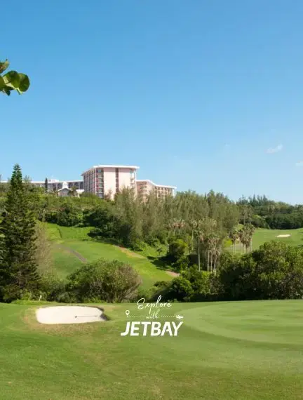 Pristine golf course with sand bunker overlooking luxury resort hotels in Southampton, Bermuda