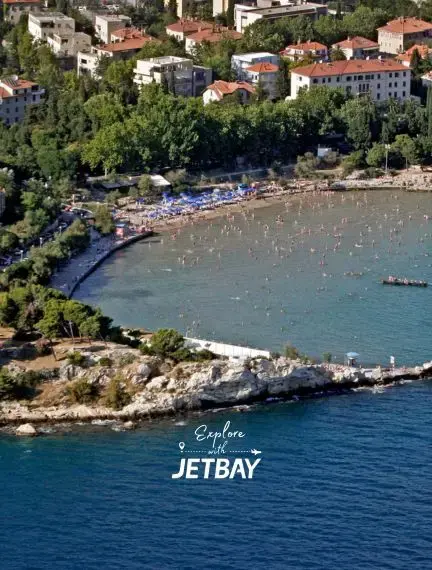 Aerial view of Split's pristine coastline with turquoise waters, rocky cliffs, and Mediterranean villas