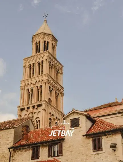 Historic bell tower of Split Cathedral rises above traditional Croatian stone buildings with terracotta roofs