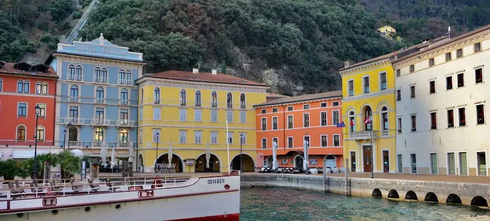Colorful historic waterfront buildings in Split harbor with traditional boat moored alongside stone quay