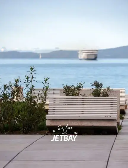 Waterfront promenade in Split with Mediterranean vegetation overlooking Adriatic Sea and distant islands