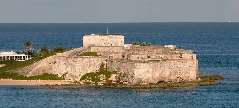 Historic Royal Naval Dockyard fortress on turquoise waters showcasing Bermuda's maritime heritage in St Georges