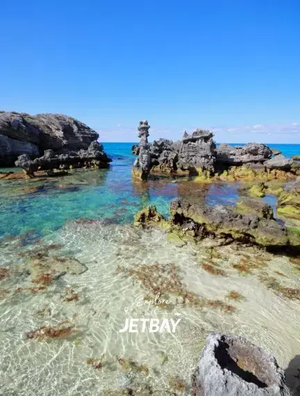 Crystal clear turquoise waters and dramatic limestone formations create a pristine swimming cove in St Georges
