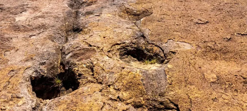 Ancient limestone formations with natural cavities and weathered rock surfaces in Sucre's geological landscape