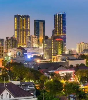 Surabaya skyline at twilight showcasing modern skyscrapers and urban development in Indonesia's second largest city