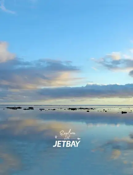 Tranquil lagoon waters reflecting dramatic sunset clouds in Suva, Fiji for luxury travel exploration
