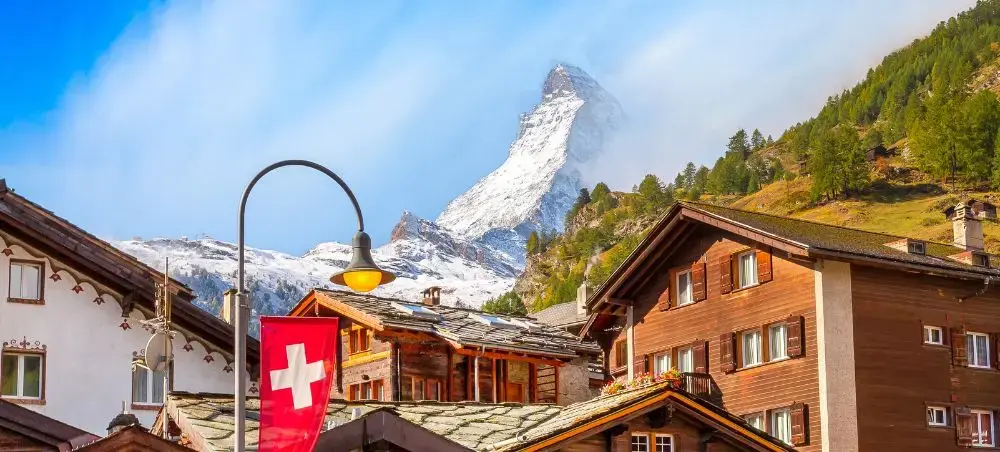 Traditional Swiss chalets with wooden balconies nestled beneath the iconic Matterhorn peak in Zermatt