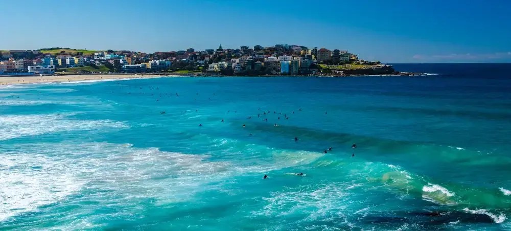 Stunning turquoise waters and pristine coastline of Sydney's famous beaches with surfers enjoying perfect waves