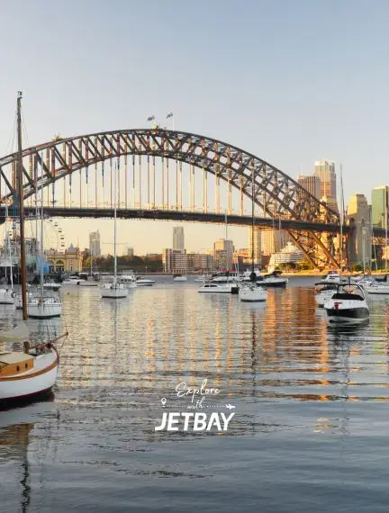 Sydney Harbour Bridge spans golden waters with luxury yachts moored below, showcasing Australia's premier destination