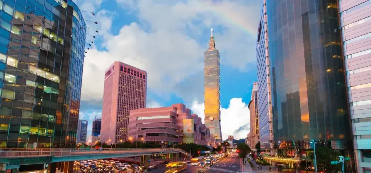 Taipei's modern skyline featuring Taipei 101 tower surrounded by illuminated skyscrapers at dusk