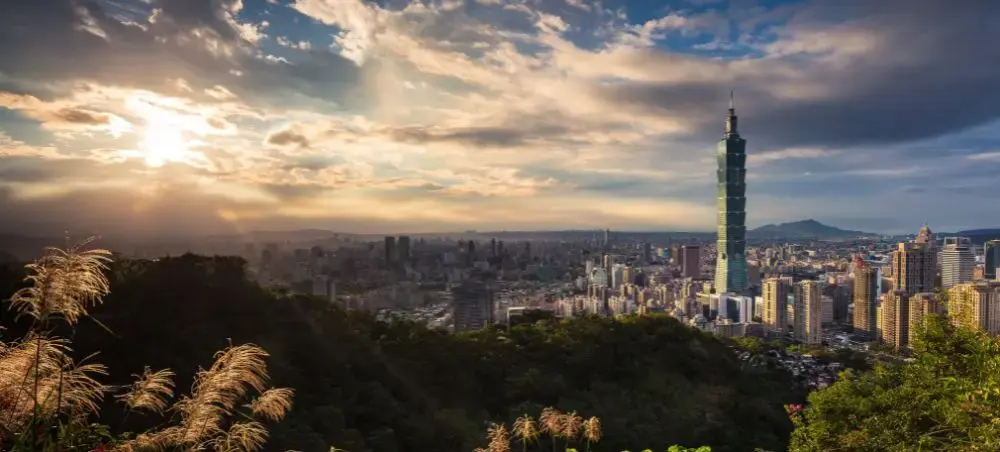 Taipei skyline at sunset featuring Taipei 101 tower and urban landscape from elevated viewpoint in Taiwan