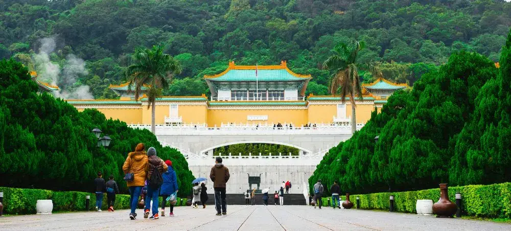 National Palace Museum in Taipei showcasing traditional Chinese architecture amid lush green mountains