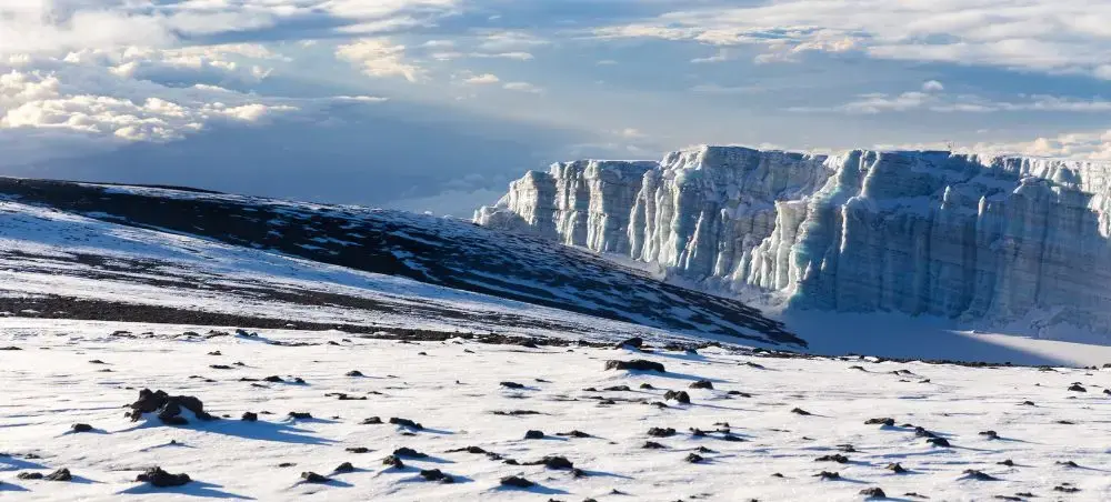 Snow-covered Kilimanjaro glacier walls and summit plateau showcasing Tanzania's iconic mountain peak