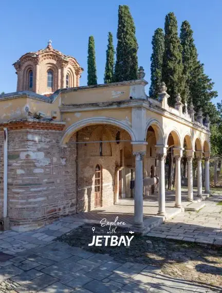 Byzantine monastery with distinctive red dome and white colonnade in historic Thessaloniki, Greece
