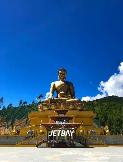Golden Buddha Dordenma statue overlooking Thimphu valley with Jetbay branding, showcasing Bhutan's spiritual heritage