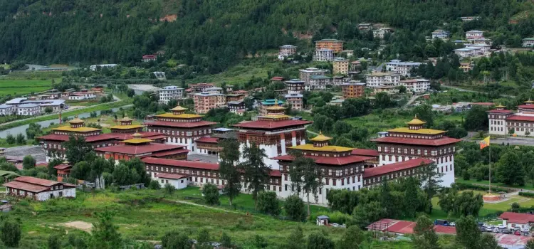 Tashichho Dzong fortress and traditional Bhutanese architecture in Thimphu valley surrounded by mountains