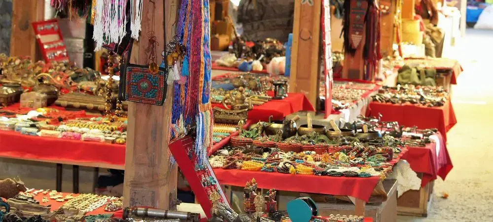 Traditional handicraft market stalls in Thimphu displaying colorful textiles, jewelry and souvenirs