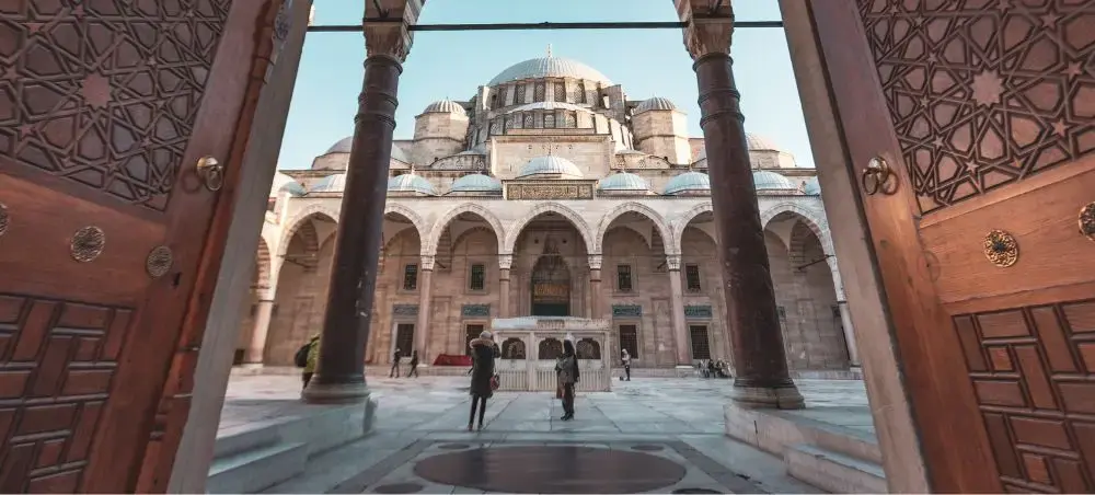 Ornate courtyard view of historic Ottoman mosque in Istanbul showcasing Turkey's architectural heritage