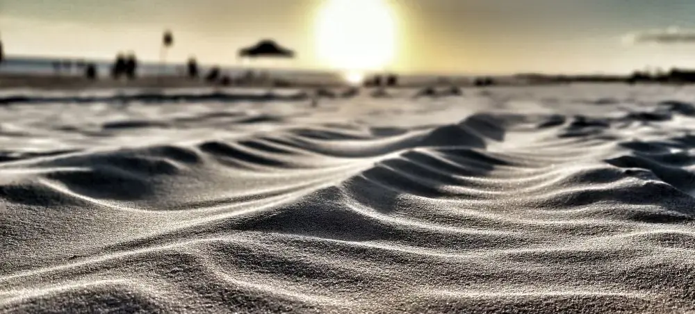 Wind-sculpted sand dunes create dramatic patterns along Uruguay's pristine Atlantic coastline at sunset