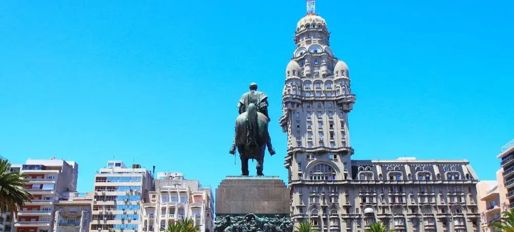 Historic Montevideo cityscape featuring Palacio Salvo tower and Independence Plaza monument in Uruguay