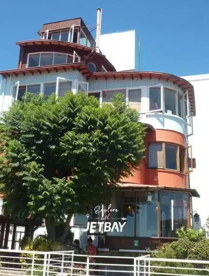 Colorful curved architecture building with Jetbay branding in historic Valparaiso Chile waterfront district