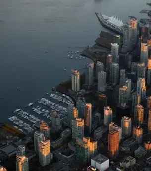 Aerial view of Vancouver's downtown skyline and waterfront at golden hour showcasing the city's luxury appeal