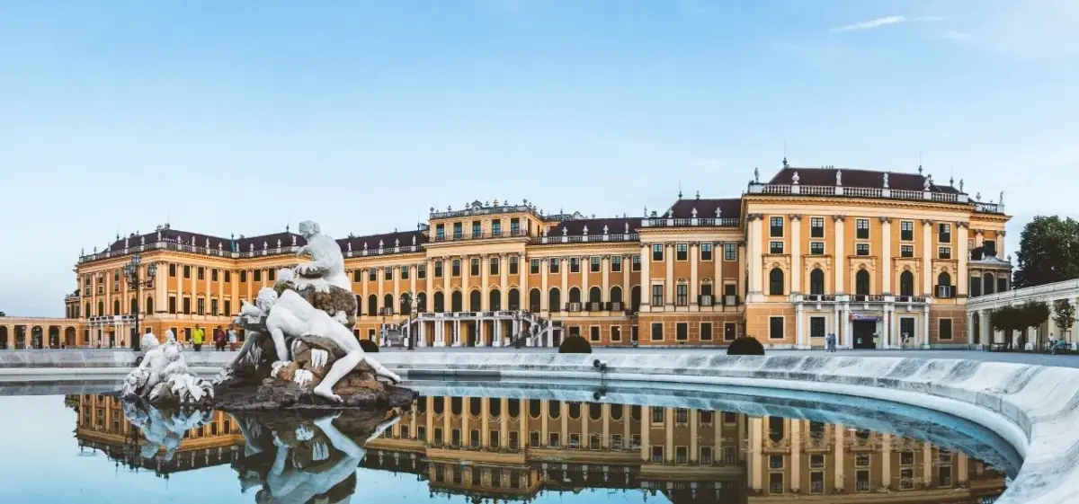 Schönbrunn Palace reflecting in ornate fountain waters showcasing Vienna's imperial baroque architecture