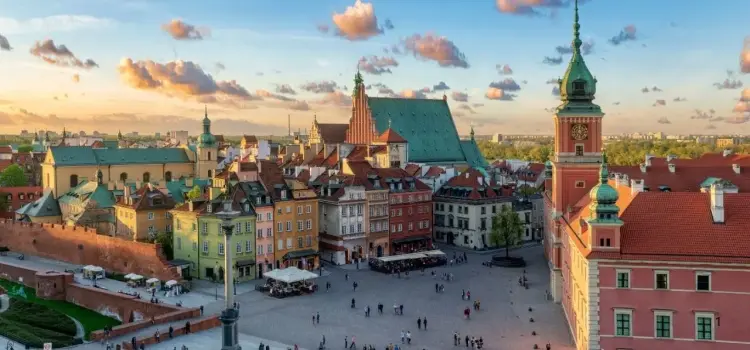 Warsaw Old Town square at golden hour showcasing colorful historic buildings and Royal Castle tower