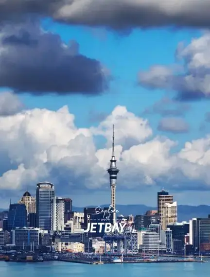 Wellington skyline featuring Sky Tower and harbor under dramatic clouds for luxury jet charter travel