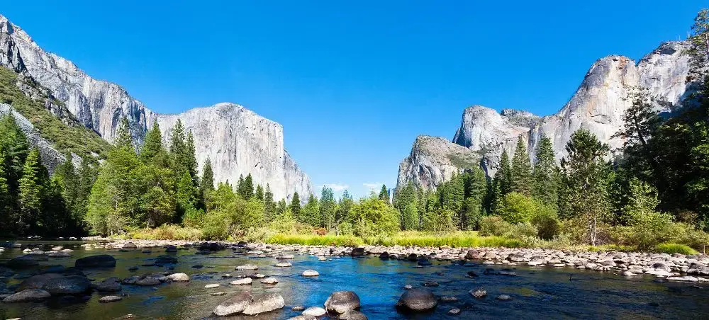 Yosemite Valley's granite cliffs and Merced River showcasing California's premier destination for luxury travel