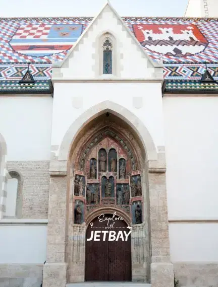 Historic Gothic church entrance with colorful tiled roof in Zagreb, Croatia for luxury travel exploration