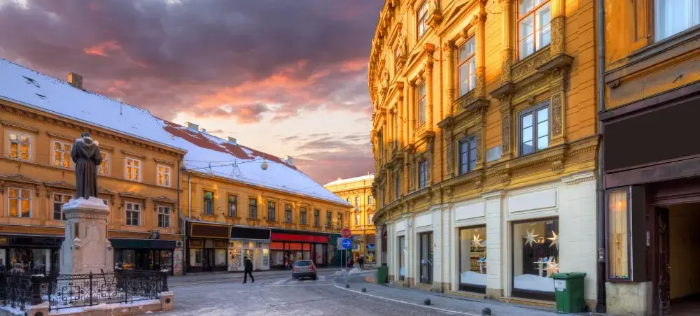 Historic Zagreb city center with baroque architecture and cobblestone square at golden hour sunset