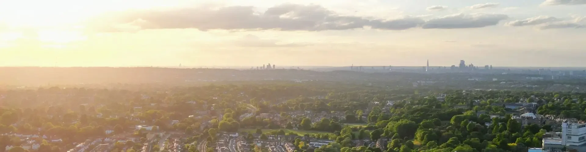 Aerial view of Biggin Hill Airport surrounded by residential neighborhoods at golden hour sunset