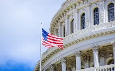 American flag waving beside the iconic Capitol dome in Washington DC for luxury private jet travel