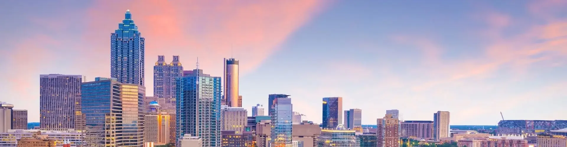 Atlanta skyline at sunset showcasing downtown skyscrapers and highways for private jet charter access