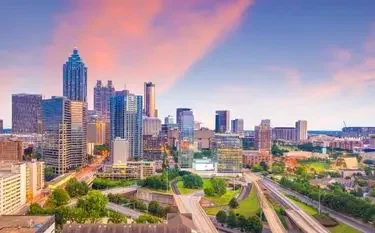 Atlanta skyline at sunset showcasing downtown skyscrapers and highways for private jet charter access