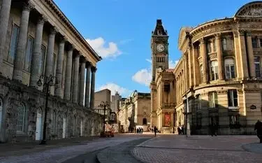 Private Jet from Birmingham to Manchester Birmingham city center neoclassical buildings clock tower blue sky for private jet charter passengers