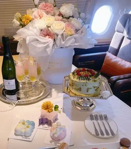 Elegant for a birthday celebration private jet champagne decorated cake fresh flowers card item