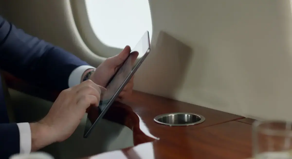 Business executive with tablet luxury private private jet for a valentines day planning