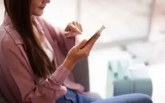 Business traveler using smartphone to book private jet charter for efficient corporate travel