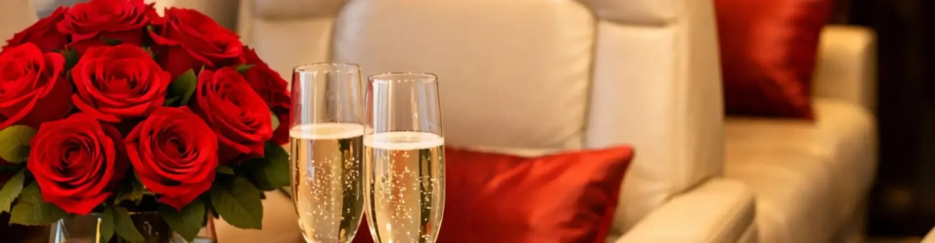 Charter a Private Jet Flight for Valentine’s Day Romantic private jet cabin with champagne flutes red roses heart shaped gift box
