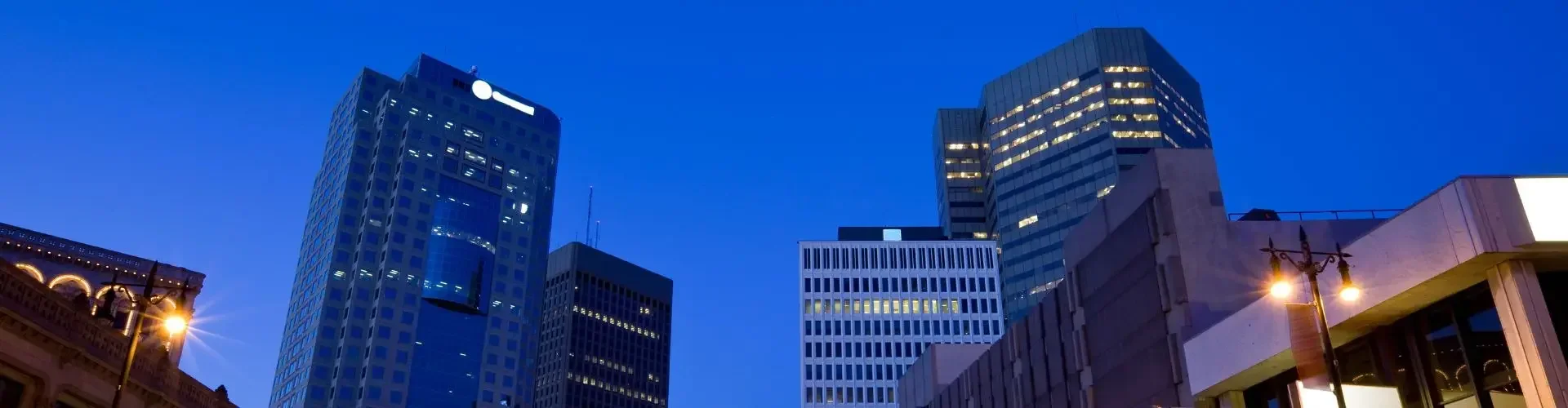 Private Jet from Winnipeg to Toronto Downtown winnipeg skyline dusk illuminated skyscrapers light trails for private jet charter passengers