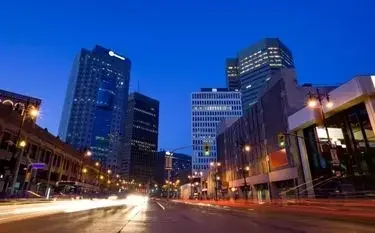 Private Jet from Winnipeg to Toronto Downtown winnipeg skyline dusk illuminated skyscrapers light trails for private jet charter passengers