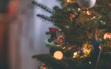 Festively decorated for a christmas tree warm golden lights ornaments holiday ambiance