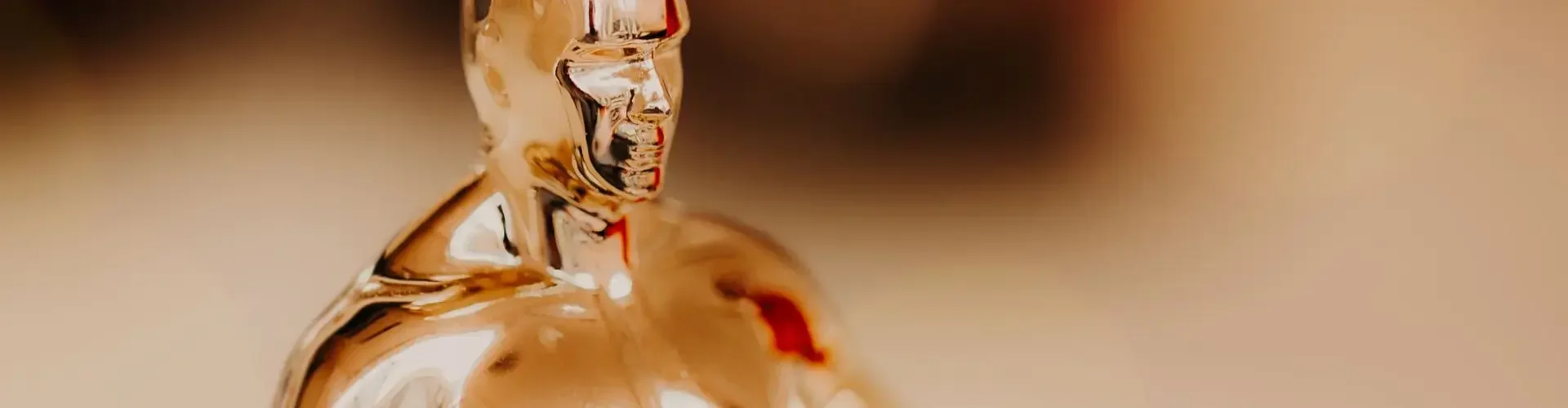 Private Jet Charter to the Academy Awards 2026 Golden oscar statuette gleaming warm light symbolizing hollywood academy awards for private jet charter passengers